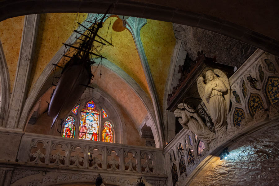 Carved boats hang from the ceiling in the Chapelle Notre Dame, Rocamadour